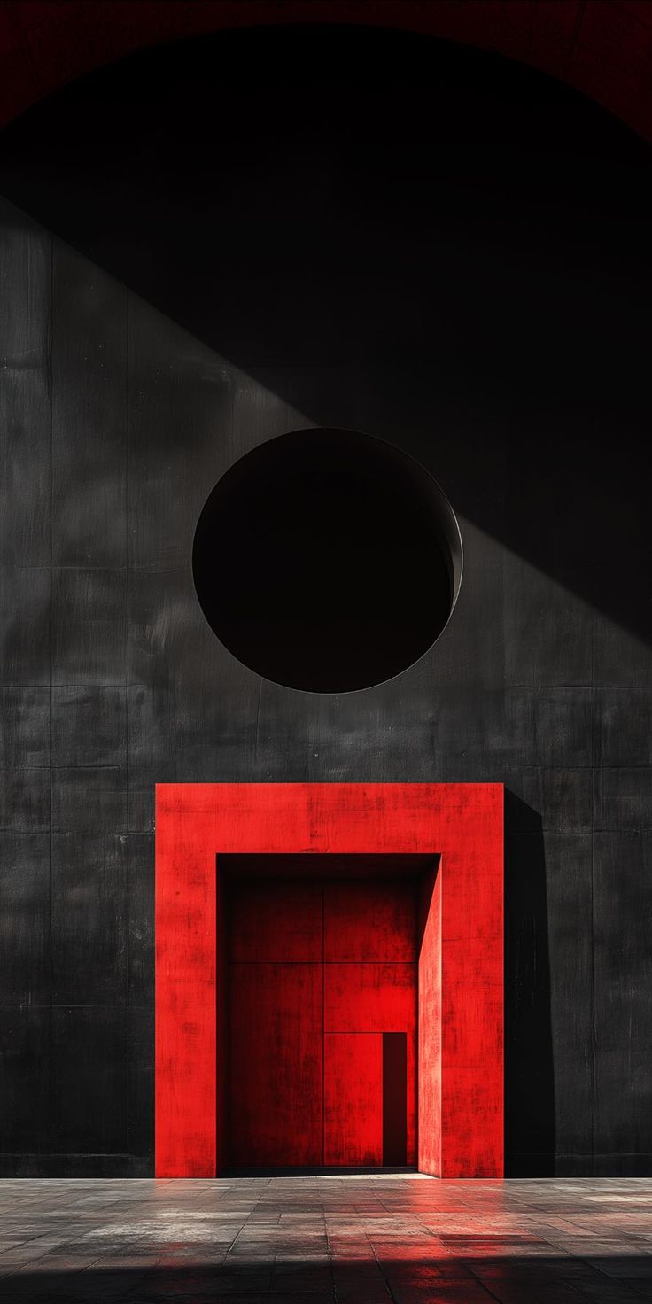 Mur noir percé d'un cercle avec portail rouge — architecture contemporaine